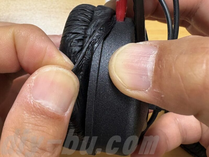 新しいイヤーパッドをヘッドホンに装着している手元